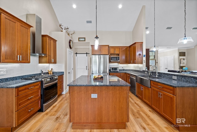 1609 Makaira Dr, Foley, AL 36535 - kitchen with appliances with stainless steel finishes, a sink, wall chimney exhaust hood, a peninsula, and decorative backsplash