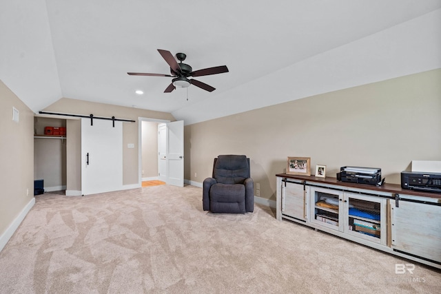 1609 Makaira Dr, Foley, AL 36535 - living area with vaulted ceiling, ceiling fan, carpet flooring, baseboards, and a barn door