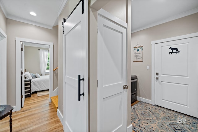 1609 Makaira Dr, Foley, AL 36535 - entrance foyer featuring a barn door, light wood finished floors, crown molding, recessed lighting, and baseboards