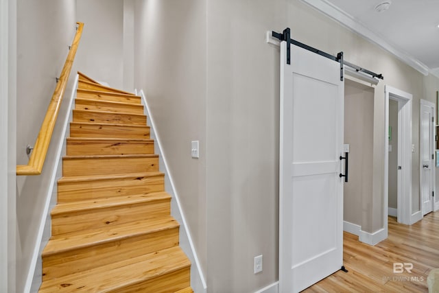 1609 Makaira Dr, Foley, AL 36535 - stairs featuring a barn door, baseboards, crown molding, and wood finished floors