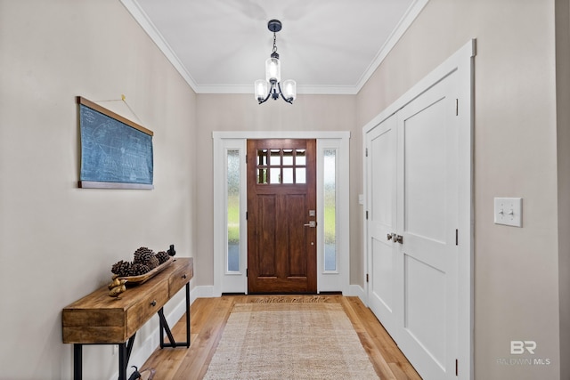 1609 Makaira Dr, Foley, AL 36535 - entryway with light wood finished floors, crown molding, a chandelier, and baseboards