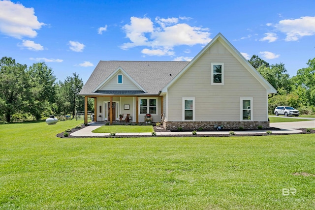 1609 Makaira Dr, Foley, AL 36535 - view of front facade featuring a front yard, covered porch, and roof with shingles