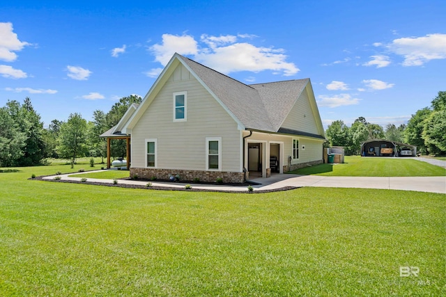 1609 Makaira Dr, Foley, AL 36535 - view of side of home featuring concrete driveway, a yard, a detached carport, brick siding, and a shingled roof