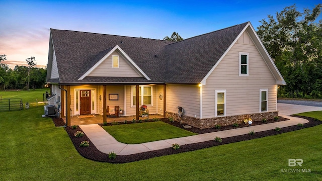 1609 Makaira Dr, Foley, AL 36535 - view of front of property with a shingled roof, a porch, and central AC unit