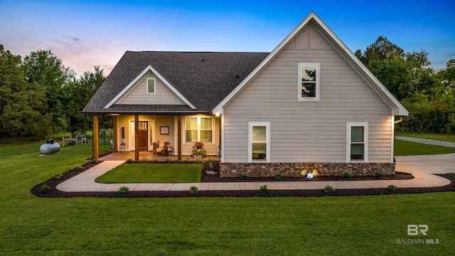1609 Makaira Dr, Foley, AL 36535 - view of front of home with a lawn, covered porch, and a shingled roof