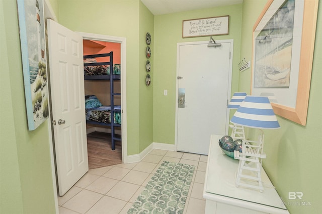 foyer entrance with baseboards and light tile patterned floors