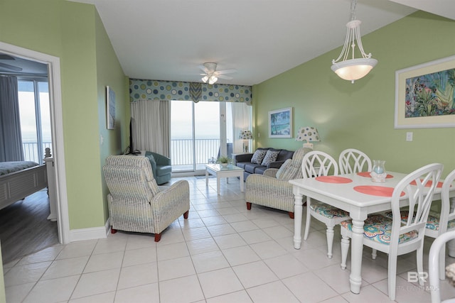 dining space featuring light tile patterned floors, ceiling fan, and baseboards