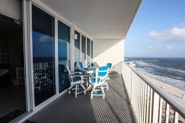 balcony with a beach view and a water view