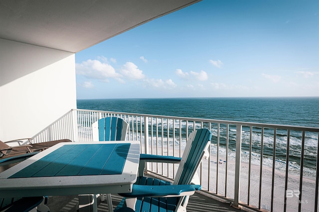 balcony with a water view and a beach view