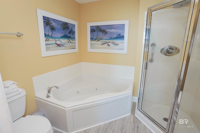 full bath featuring a stall shower, a garden tub, and toilet