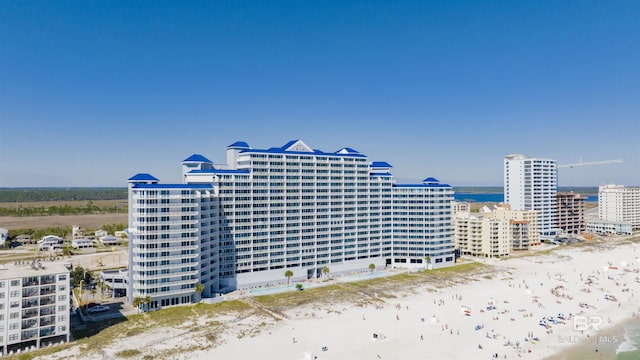 view of property with a view of city, a beach view, and a water view