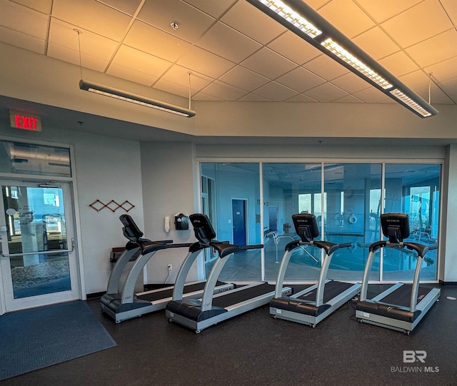 exercise room with a paneled ceiling