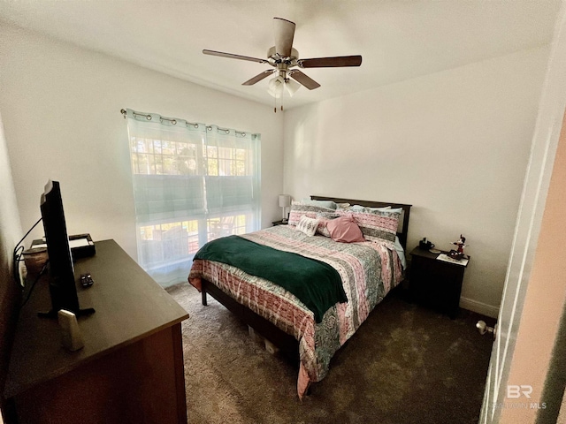 bedroom featuring ceiling fan and dark colored carpet