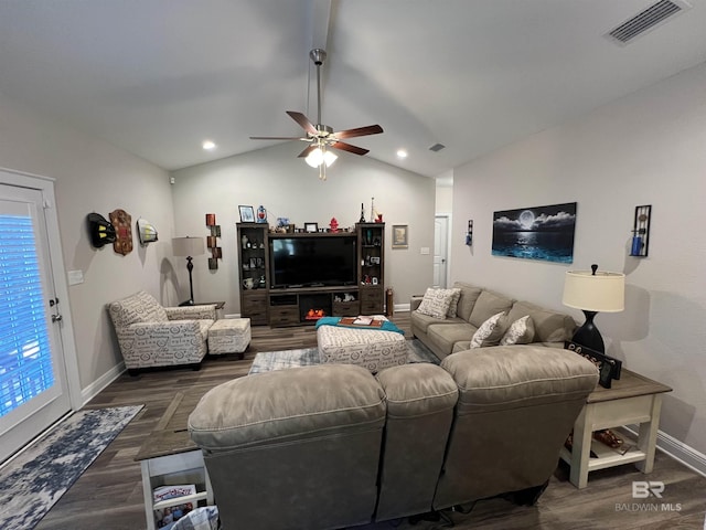 living room with dark hardwood / wood-style floors, ceiling fan, and vaulted ceiling