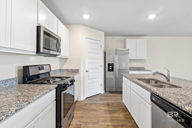 kitchen featuring white cabinets, sink, a center island with sink, dishwasher, and dark hardwood / wood-style flooring