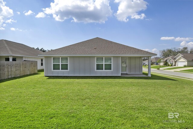 view of side of home with a yard