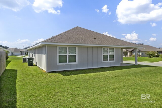 view of side of property with a yard