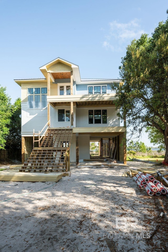 16880 Brigadoon Trl, Gulf Shores, AL 36542 - coastal inspired home featuring a carport, stairway, and dirt driveway