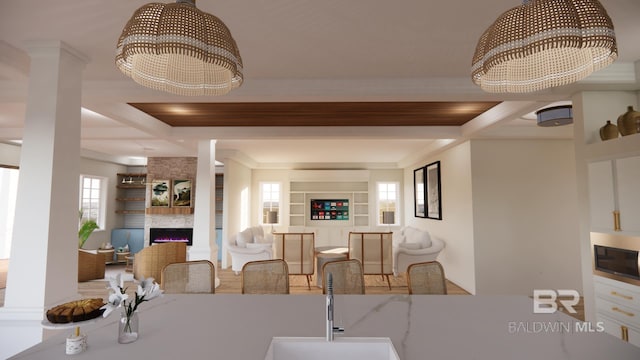 16880 Brigadoon Trl, Gulf Shores, AL 36542 - dining area featuring a chandelier, ornamental molding, a fireplace, beam ceiling, and coffered ceiling