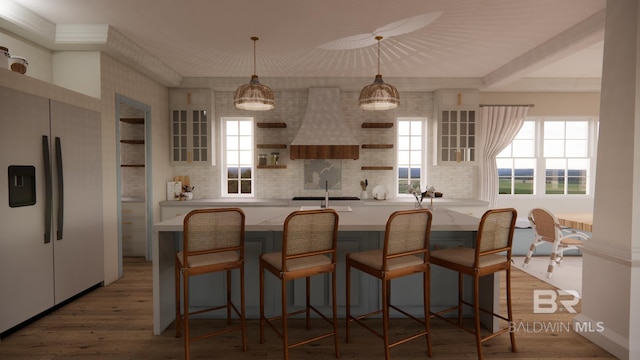 16880 Brigadoon Trl, Gulf Shores, AL 36542 - kitchen with fridge, custom range hood, backsplash, and plenty of natural light