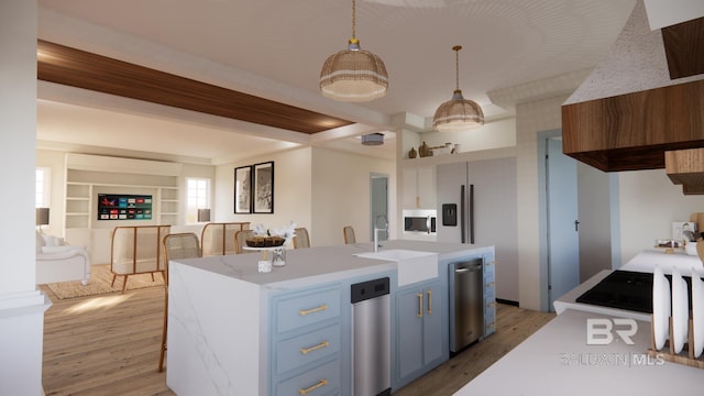 16880 Brigadoon Trl, Gulf Shores, AL 36542 - kitchen featuring blue cabinetry, light countertops, light wood-type flooring, pendant lighting, and an island with sink