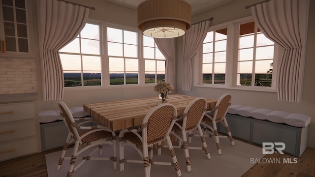 16880 Brigadoon Trl, Gulf Shores, AL 36542 - dining area featuring plenty of natural light and wood finished floors
