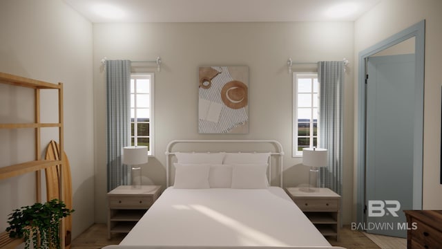 16880 Brigadoon Trl, Gulf Shores, AL 36542 - bedroom featuring multiple windows and wood finished floors
