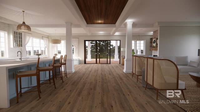 16880 Brigadoon Trl, Gulf Shores, AL 36542 - hallway with ornate columns, wood finished floors, beamed ceiling, coffered ceiling, and a chandelier