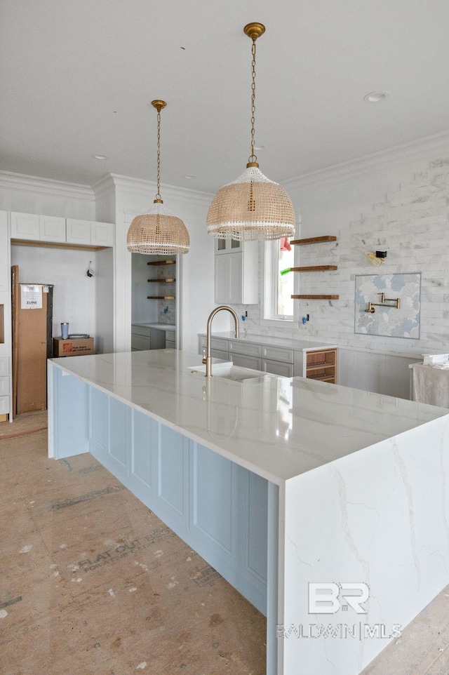 16880 Brigadoon Trl, Gulf Shores, AL 36542 - kitchen with ornamental molding, light stone countertops, pendant lighting, open shelves, and a large island