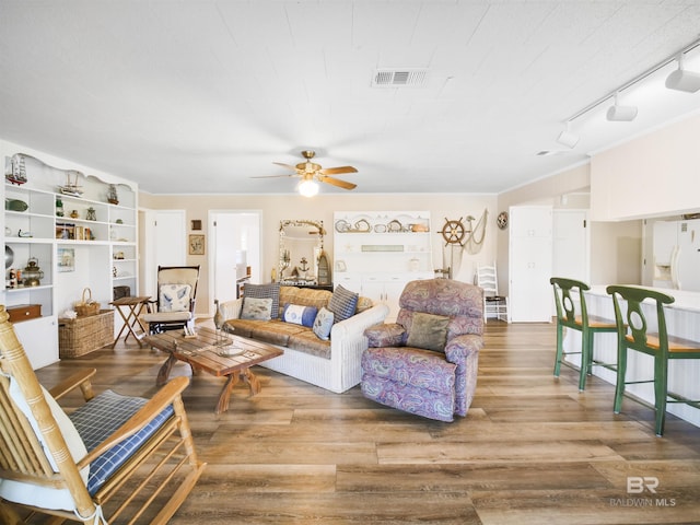 living room featuring hardwood / wood-style floors, track lighting, and ceiling fan
