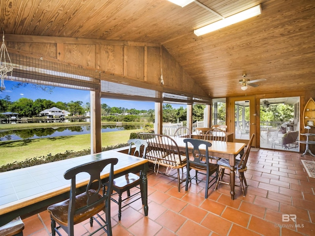 sunroom / solarium with french doors, a water view, vaulted ceiling, ceiling fan, and wood ceiling
