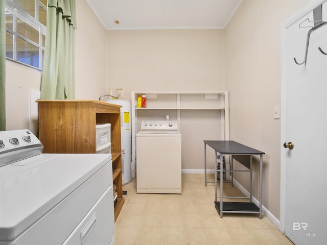 clothes washing area featuring electric water heater, separate washer and dryer, and ornamental molding