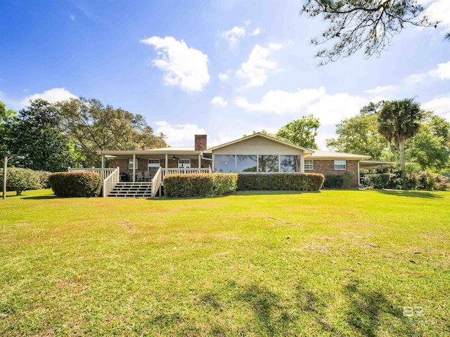 back of house with a porch and a yard
