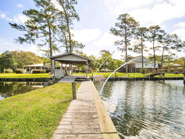 view of dock featuring a lawn and a water view
