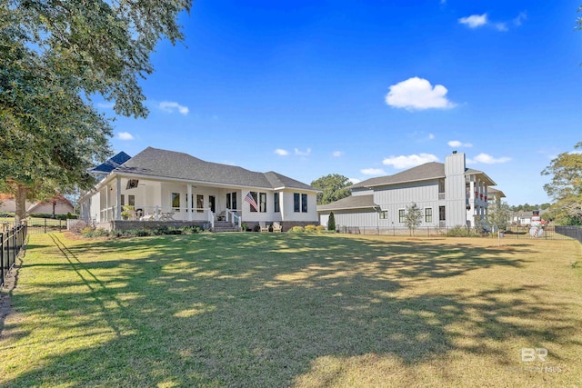 view of front of house with a front yard and covered porch