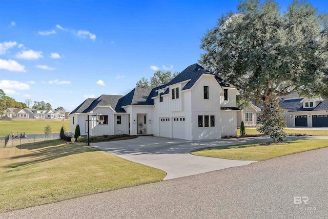 modern inspired farmhouse with a front yard and a garage