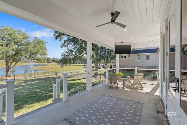 view of patio / terrace with a water view and ceiling fan