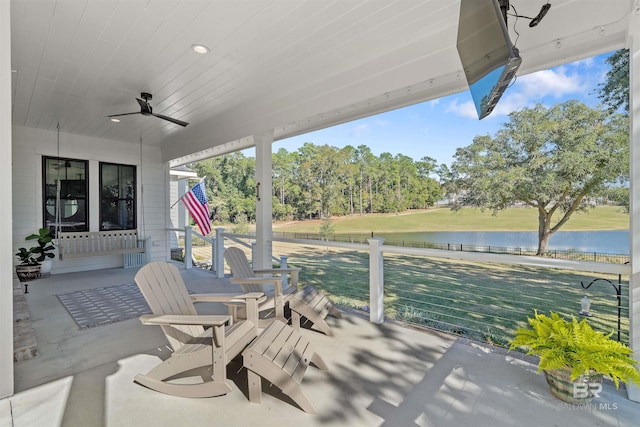 view of patio featuring ceiling fan and a water view