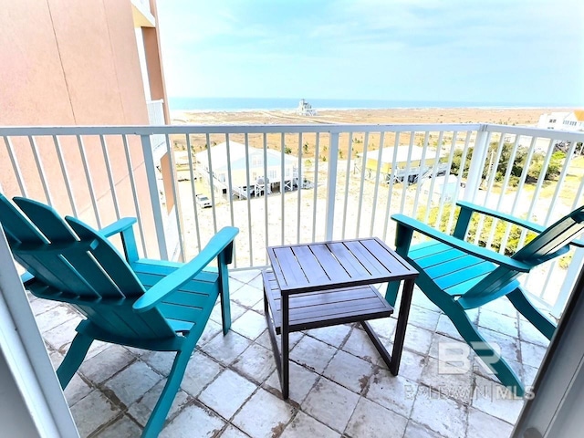 balcony with a beach view and a water view