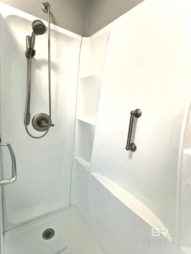 bathroom featuring a shower stall