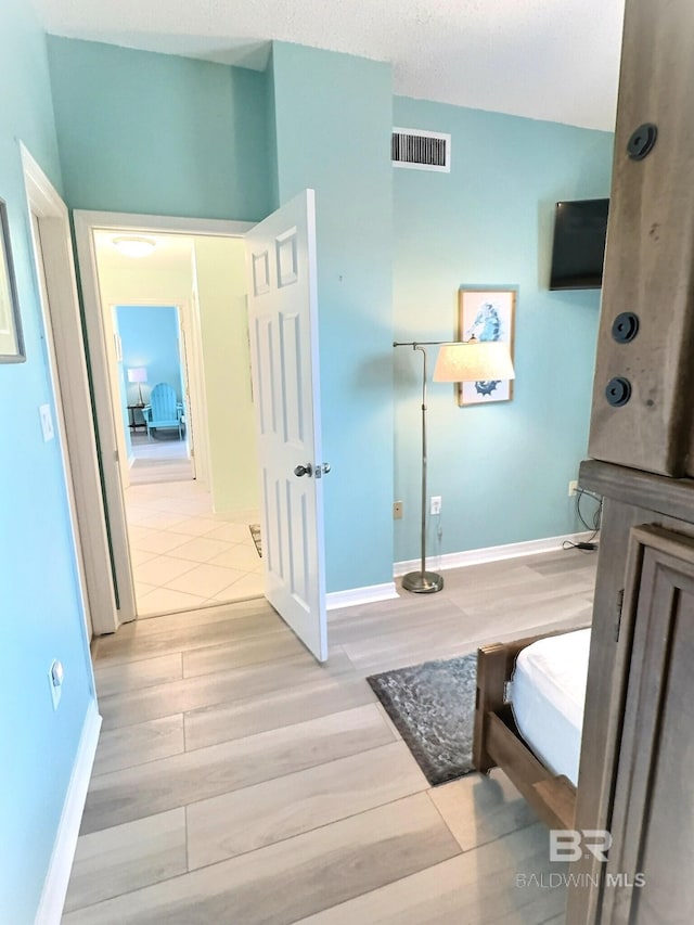 interior space featuring wood finished floors, visible vents, and baseboards