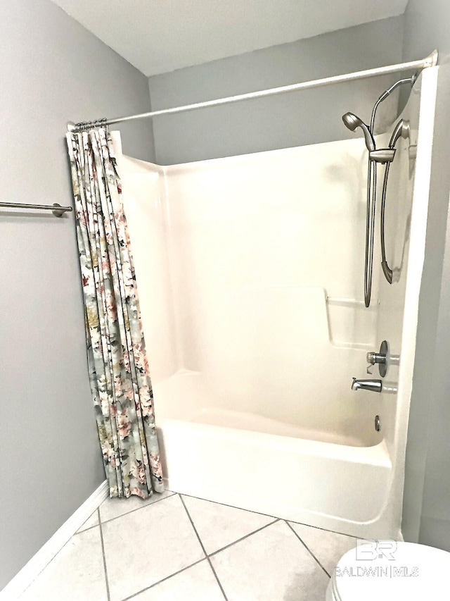 full bath featuring tile patterned flooring, toilet, and shower / bath combo