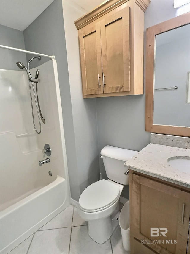 full bath with tile patterned floors, toilet, vanity, baseboards, and shower / bathtub combination