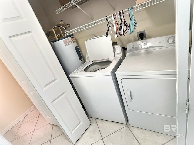 laundry area featuring laundry area, light tile patterned floors, and washer and clothes dryer