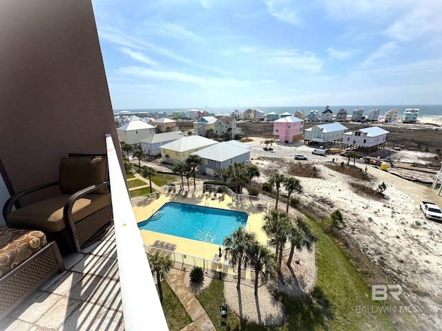 pool with a patio area and a water view