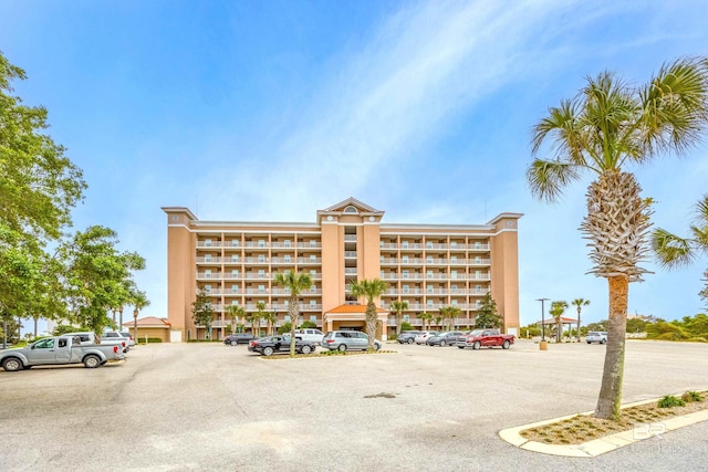 view of building exterior featuring uncovered parking