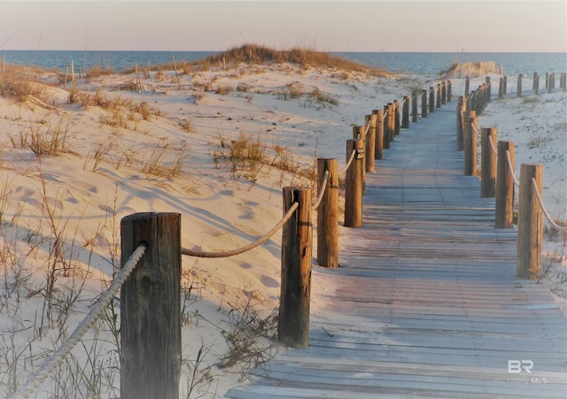 dock area featuring a beach view and a water view