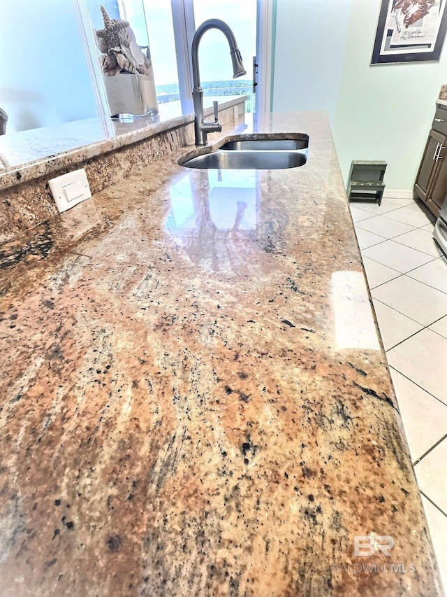 details featuring a sink and light stone counters