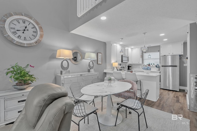 dining area featuring light wood-style floors and recessed lighting