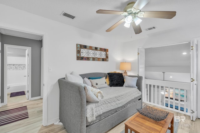 bedroom featuring visible vents, baseboards, and wood finished floors